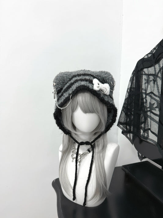 Distressed grey cat ear knit beanie with long buckle earflaps and contrast stitching.