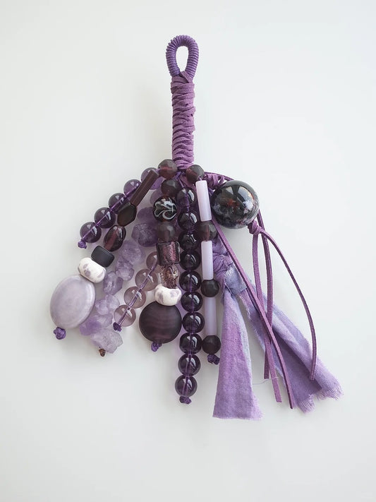 One-of-a-kind handmade bag charm with purple amethyst, glass, and ceramic beads on leather cord