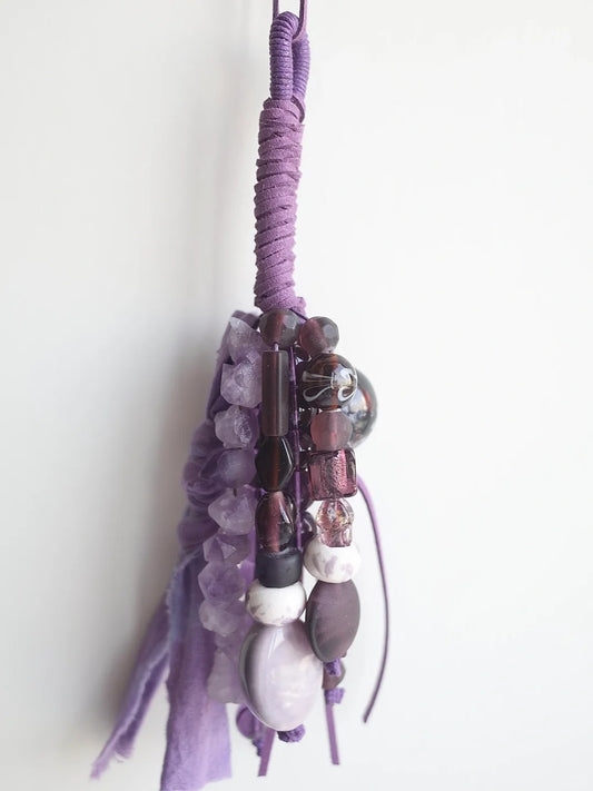 One-of-a-kind handmade bag charm with purple amethyst, glass, and ceramic beads on leather cord
