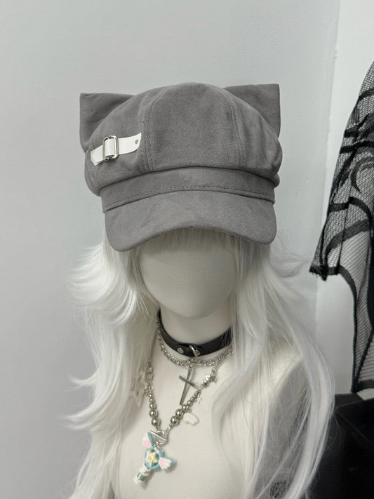 Slate grey newsboy cap with feline ears and white side buckle, soft-alt fashion.