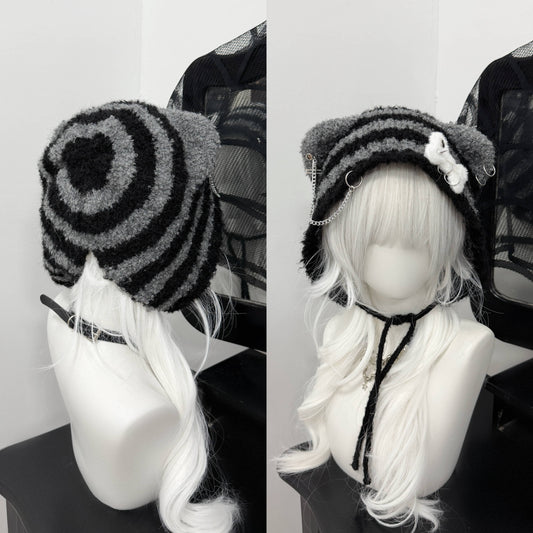 Distressed grey cat ear knit beanie with long buckle earflaps and contrast stitching.