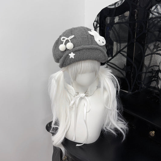 Close-up of a grey knit beret hat featuring a white Miffy bunny patch and star charms on a mannequin with white pigtails, Y2K Harajuku style fashion accessory.