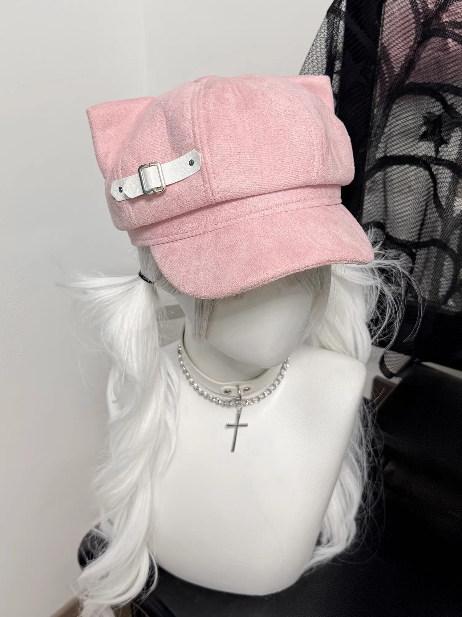 Pastel pink cat ear newsboy cap with white leather buckle strap, kawaii aesthetic.