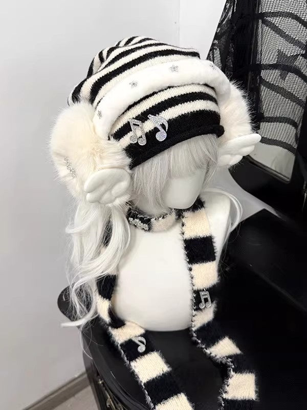 Complete 3-piece winter set featuring a black and white striped beanie, plush snowflake earmuffs, and matching long scarf with musical note charms.