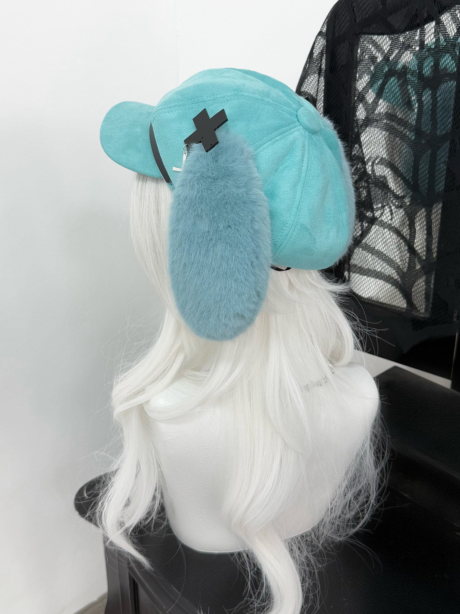 Mint green newsboy cap with long plush puppy ears, a black leather belt buckle, and metal cross charms, Hatsune Miku inspired aesthetic.