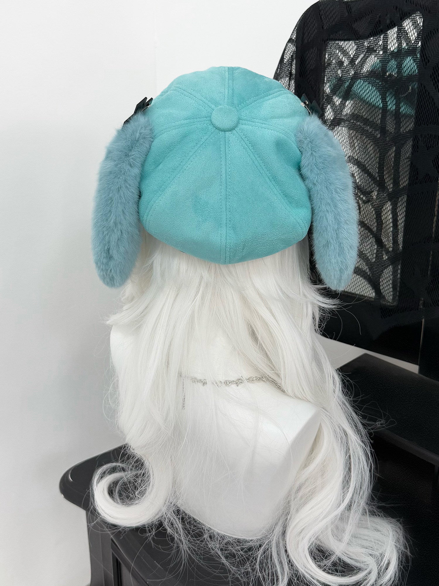 Mint green newsboy cap with long plush puppy ears, a black leather belt buckle, and metal cross charms, Hatsune Miku inspired aesthetic.