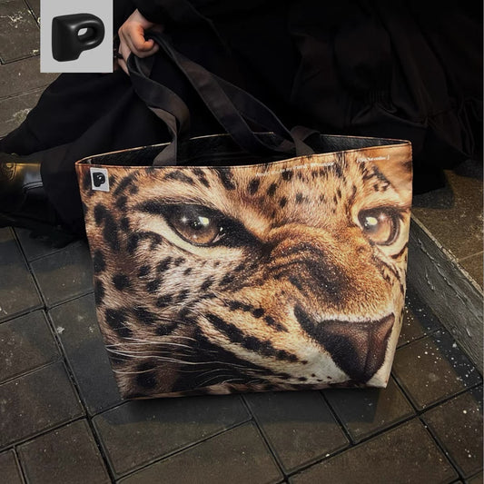 Tote bag with a leopard print design on a tiled floor.