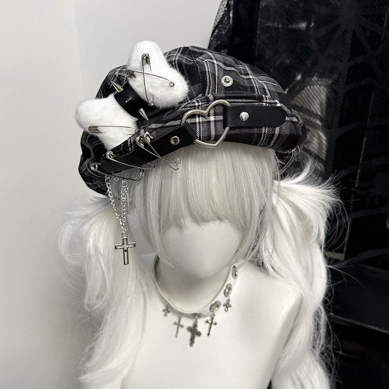 Black and grey plaid cyber-punk beret featuring metal safety pins and industrial hardware.
