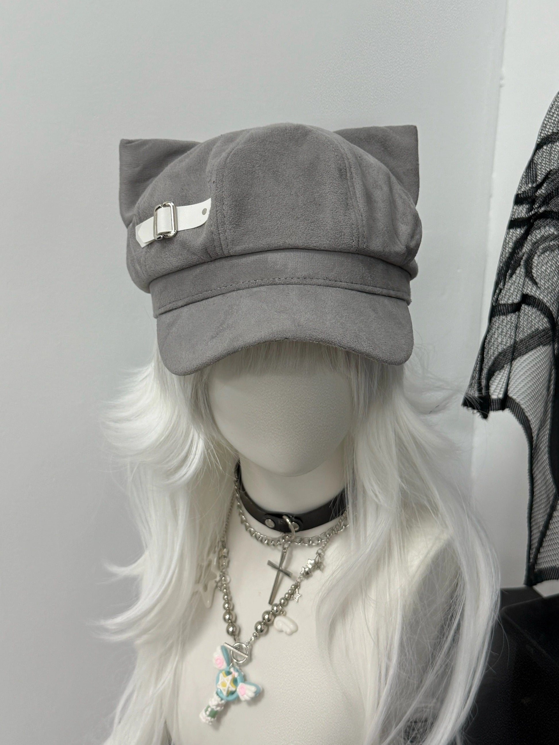 Slate grey newsboy cap with feline ears and white side buckle, soft-alt fashion.