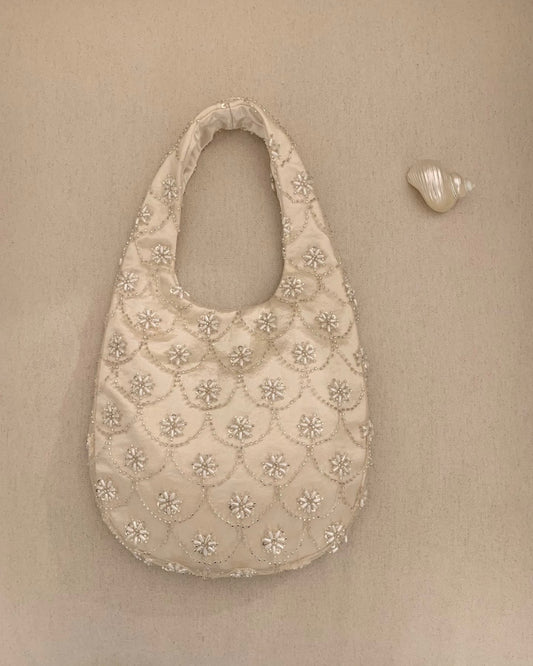 Handmade cream seed bead embroidery eggshell handbag for weddings and evening galas, luxury bridal purse with multi-layer satin lining and intricate floral beadwork.