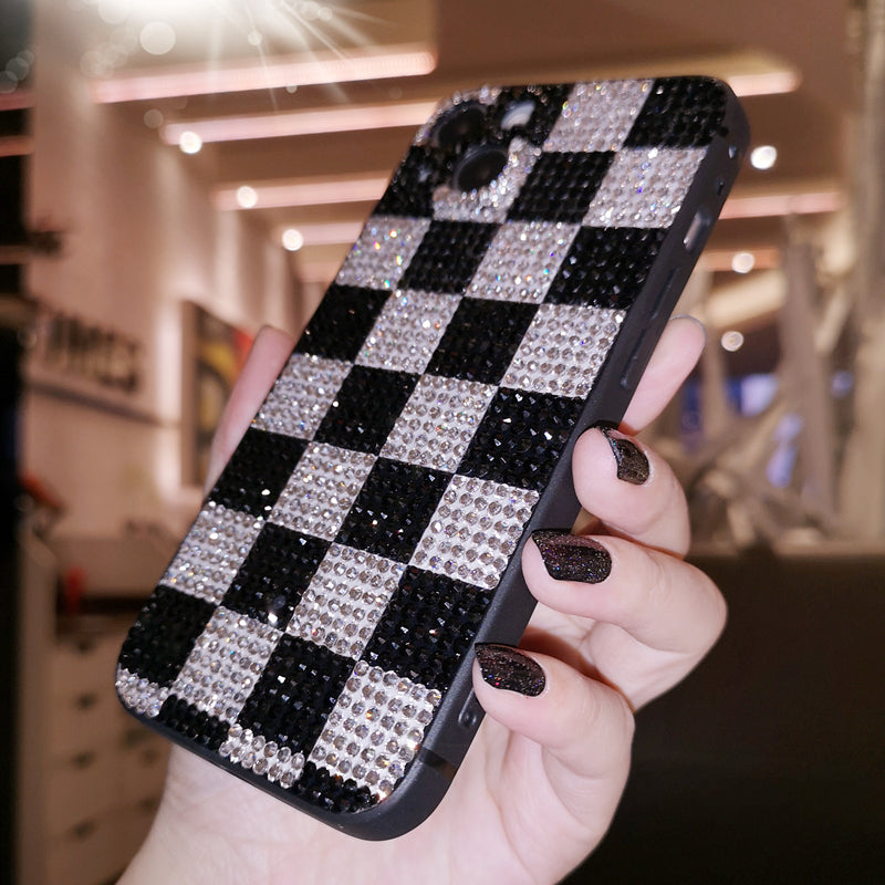 Handcrafted rhinestone black and white checkered phone case with a shiny, sparkling finish, designed for iPhone models.