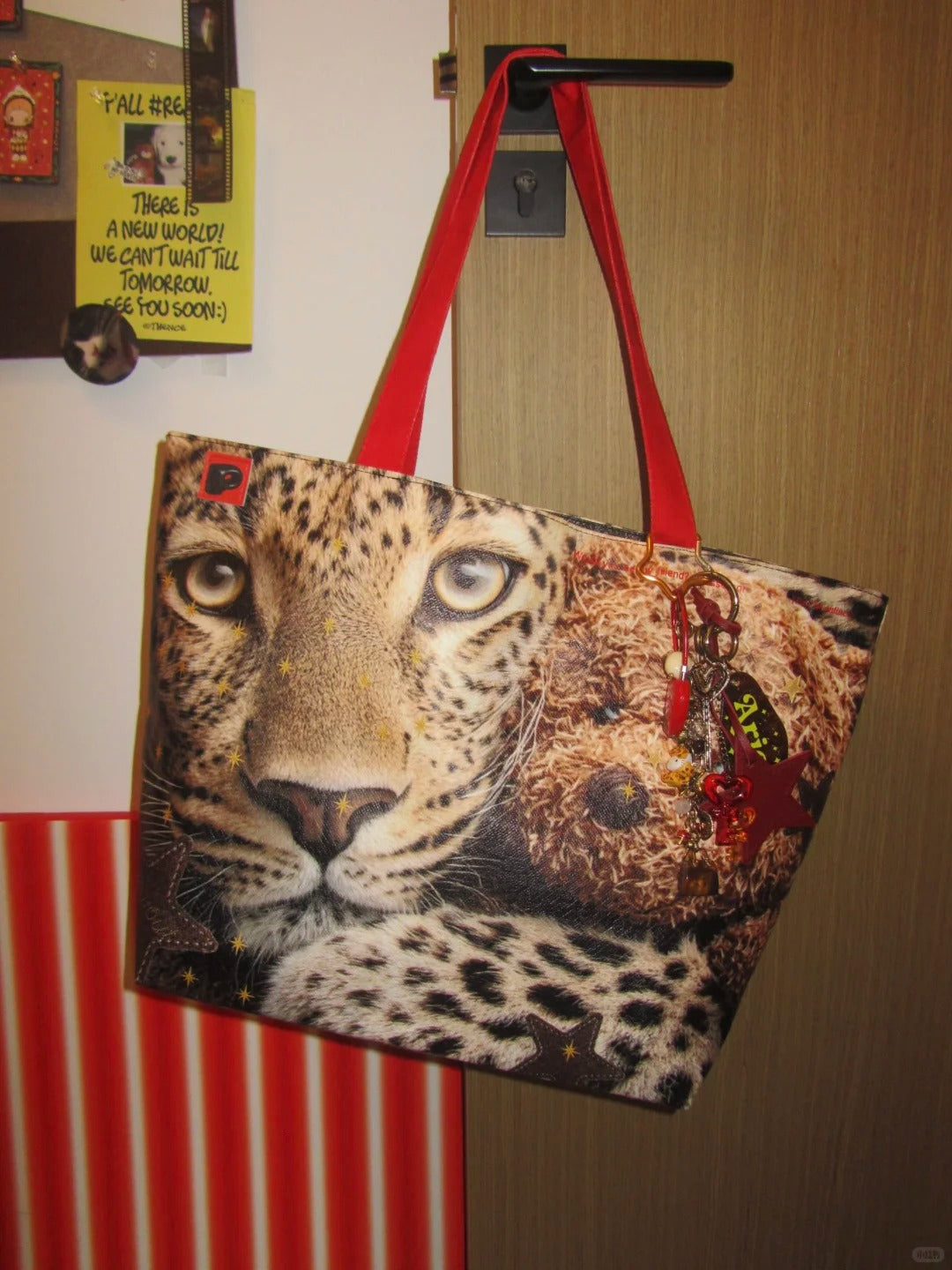 Tote bag with a leopard design hanging on a door