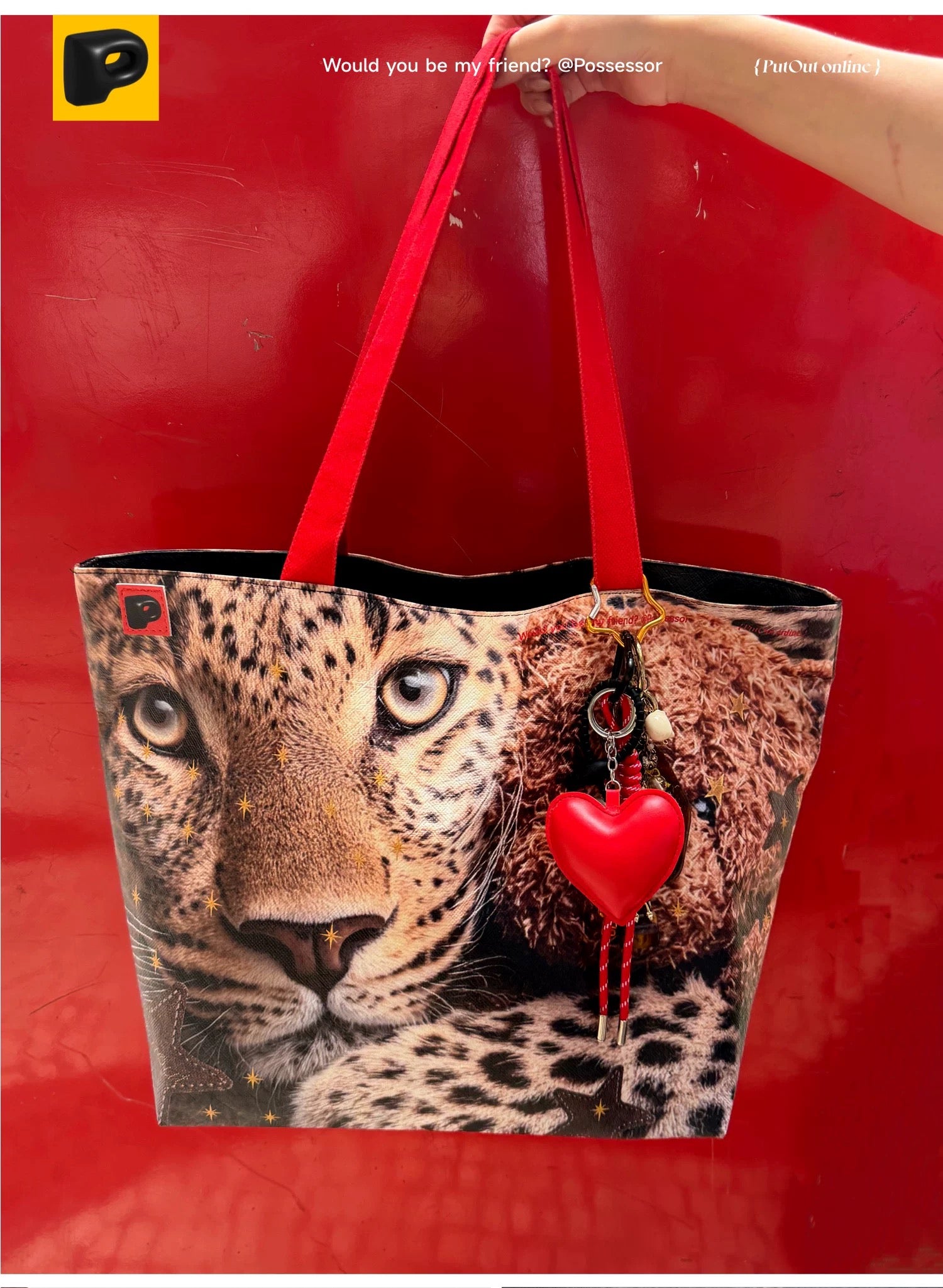 Leopard print bag with red heart and strap on a red background